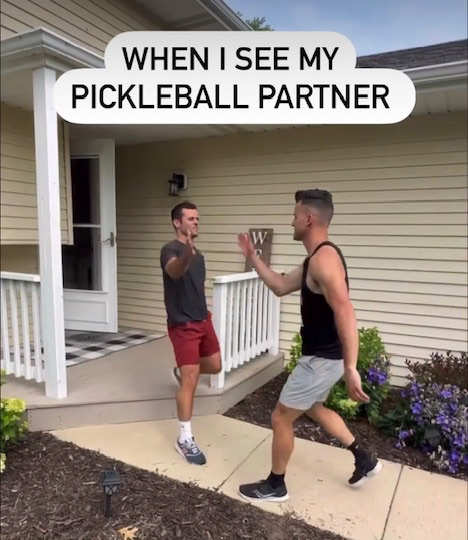 Dou pickleball players greeting each other