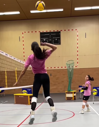 Volleyball player spiking a volleyball